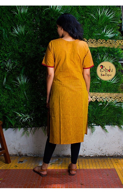 Yellow colored kurti with green patch